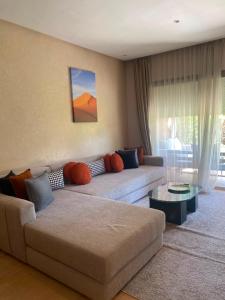 a living room with a couch and a table at Prestigia Marrakech in Inezgane