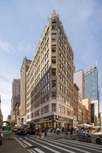 a tall building on a city street with a crosswalk at Madison Square Studio at Return Policy Broadway in New York