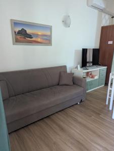 a living room with a couch and a tv at Villa cesar in Costa Paradiso