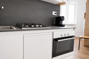 a kitchen with a stove top oven next to a sink at La Piazzetta in Cingoli +9 photos