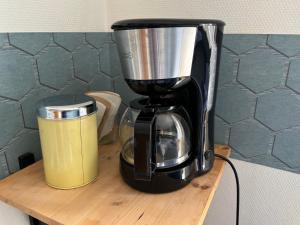 a coffee maker sitting on top of a wooden table at Bed en Brood Prunushof in Zelhem