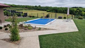 a swimming pool in a yard next to a field at Lazarica in Divoš +7 photos