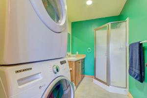 a washing machine in a bathroom with green walls at The Osprey Perch in Garfield