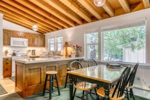 a kitchen with a wooden ceiling and a table and chairs at Single Level Ranch Condo in Elkhorn in Sun Valley