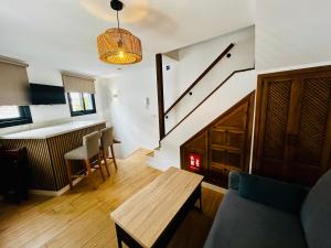 a living room with a table and a staircase at Casa Cazorla in Ojén