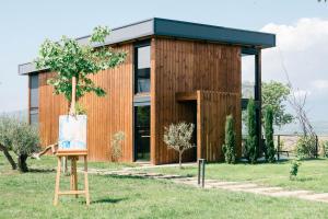 a wooden house with a sign in front of it at Salinas Nest - Ulcinj Stoj Ada Bojana in Ulcinj