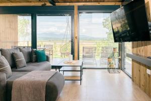 a living room with a couch and a tv and a table at Salinas Nest - Ulcinj Stoj Ada Bojana in Ulcinj +193 photos
