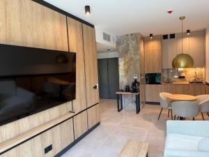 a living room with a couch and a table at Apartament - VIDOK 109 in Olsztyn +6 photos