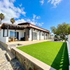 a house with a lawn in front of it at Villa Tequila in Adeje