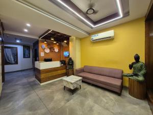 a living room with a couch and a statue at Hotel Clover in Zirakpur