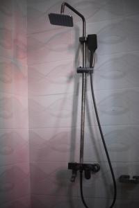 a shower with a shower head in a bathroom at G Villa Executive Hotel in Dodoma +8 photos