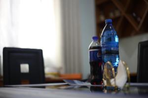 two bottles of water are sitting on a table at G Villa Executive Hotel in Dodoma