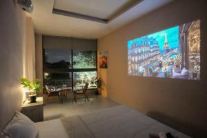 a bedroom with a large tv on the wall at Bống's Homestay and Cafe in Ho Chi Minh City