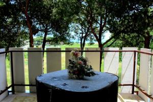 a blue table with a bouquet of flowers on it at Loft vista mare in Silvi Marina +19 photos