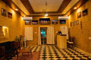 a lobby with a checkered floor and a room with a door at Desert Popular Resort & Camp in Jaisalmer