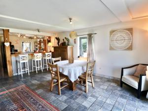 a dining room and kitchen with a table and chairs at Cocoon in Houffalize