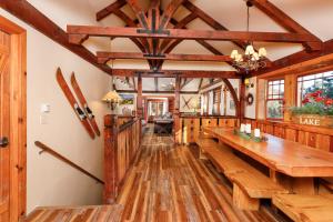 a living room with wooden floors and a long wooden table at Arrowhead Pine Rose Cabins in Twin Peaks +109 photos