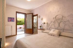 a bedroom with a large bed and a sliding glass door at Villa Mandrioli in Cecina