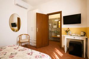 a bedroom with a bed and a fireplace and a television at Villa Mandrioli in Cecina +182 photos