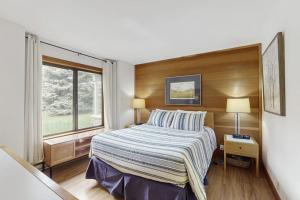 a bedroom with a bed and a window at Snowcreek 1520 in Sun Valley +47 photos
