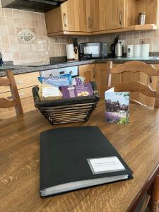 a laptop computer sitting on a table in a kitchen at Eastwood Cottage in Turriff