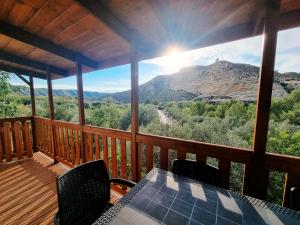 a view from the deck of a cabin with a table and chairs at Camping Port Massaluca in Pobla de Masaluca