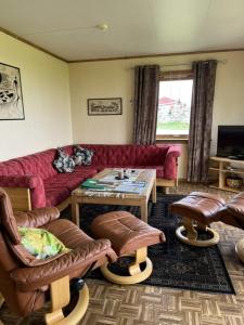 a living room with a couch and chairs and a table at Tenant Farm House in Dverberg
