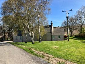 a house on the side of a road at Eastwood Cottage in Turriff +8 photos