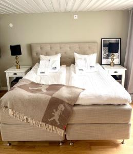 a bedroom with a large bed with two night stands at Two small houses in Ystad