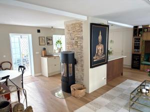 a living room with a large fireplace and a dining room at Two small houses in Ystad