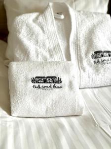two towels sitting on top of a bed at Two small houses in Ystad