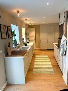 a kitchen with white cabinets and a sink at Two small houses in Ystad +13 photos