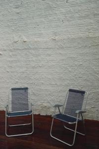 two chairs sitting in front of a white wall at Casa do Rio Âmbar - Alter do Chão in Santarém