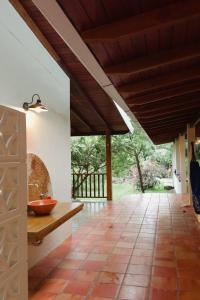 an open kitchen with a wooden ceiling and tile floor at Casa do Rio Âmbar - Alter do Chão in Santarém
