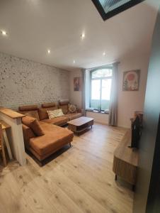 a living room with a couch and a table at L'atelier in Verviers