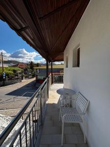 a patio with a table and a bench on a balcony at Lena Apartments 4 in Potos