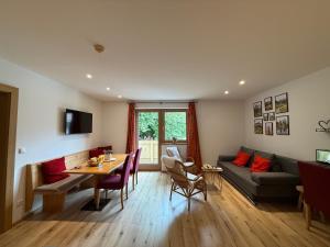 a living room with a couch and a table at Pension Mirabelle in Ellmau