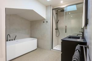 a bathroom with a tub and a sink and a shower at Château de l'Abbatiale in Braine +48 photos