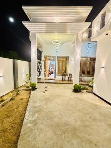 a white house at night with the lights on at Ima Manazil homestay in Kalpitiya
