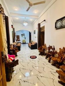 a living room with a marble floor and a couch at Ima Manazil homestay in Kalpitiya