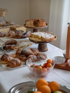 a table topped with different types of pastries and pies at Hotel Villaggio Aurora in San Pietro in Bevagna