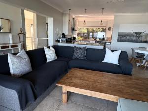 a living room with a blue couch and a coffee table at 3 Bedroom - Salt Rock Beach Pad in Ballito