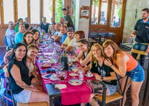 a group of people sitting at a long table at Camping Port Massaluca in Pobla de Masaluca +165 photos