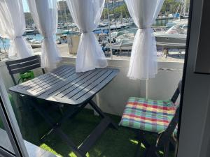 a bench on a balcony with a view of a marina at Seafront Room in Msida