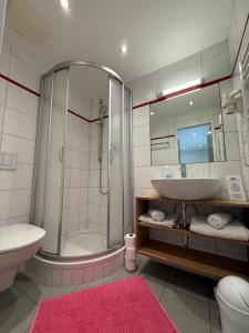 a bathroom with a sink and a shower and a toilet at Pension Mirabelle in Ellmau +96 photos