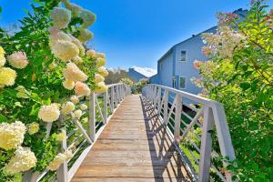 a wooden bridge with flowers and a building at Brookhaven B1 in Ludlow