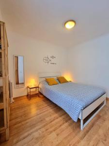 a bedroom with a bed with two yellow pillows at Casa da Anunciada | Old Town in Setúbal