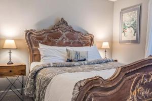 a bedroom with a large bed and two lamps at Hoffman's Historical Gathering House at Okemo in Ludlow