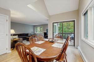 a dining room with a wooden table and chairs at Newton Village 1A in Hartford