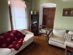 a living room with a couch and a chair at Sparta Gaia Retreat in Áyios Dhimítrios